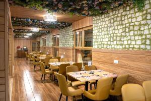 a row of tables and chairs in a restaurant at Ridge Cabin Resort in Nairobi