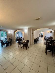 a dining room with tables and chairs and a room with tables and chairs at Le Lion D'or in Ouroux +24 photos