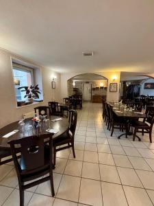 a dining room with wooden tables and chairs at Le Lion D'or in Ouroux