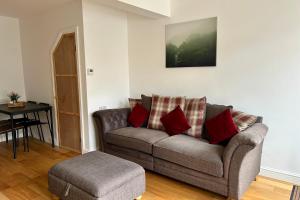 a living room with a couch and a stool at Builth wells stay in Builth Wells