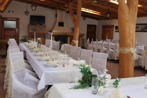 a long table with white tables and white chairs at Penzión U Tonky in Tomek +7 photos