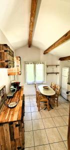 a kitchen with a table and chairs in a room at Casetta in Ortiporio
