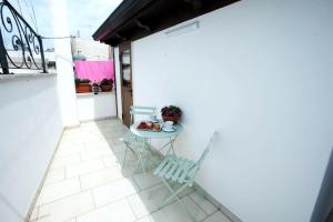 a table and a chair on a patio at Antica casa Scesciola in Rutigliano