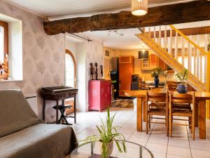 a living room with a bed and a dining room at Gîte De L'alliance in Lannion