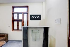 a table in a room with a sign on the wall at Hotel O Kalka in Faridabad