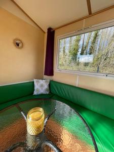 a room with a glass table and a window at Ruben Bungalow in Bourbourg