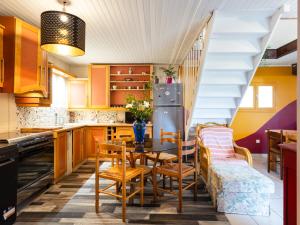 a kitchen with a table and chairs and a staircase at Gîte De L'alliance in Lannion