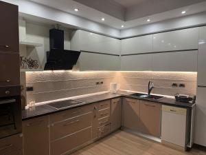 a kitchen with white cabinets and a sink at Lake Apartment in Sauk