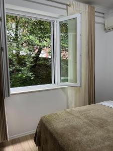 a bedroom with a large window and a bed at Lake Apartment in Sauk