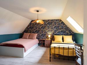 a small attic bedroom with a bed and a window at Gîte De L'alliance in Lannion
