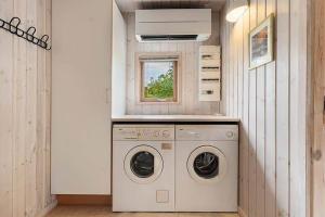 a laundry room with a washing machine and a window at HA411-Hals-Junovej-13 in Hals +12 photos