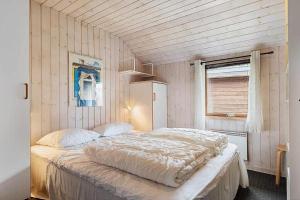 a bedroom with a large bed in a room at HA411-Hals-Junovej-13 in Hals