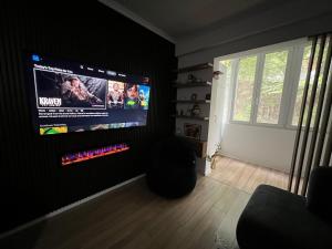 a living room with a flat screen tv on a wall at Lake Apartment in Sauk