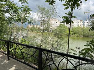 a view of a river with buildings in the background at Lake Apartment in Sauk