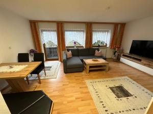 a living room with a couch and a table at Landhaus Viktoria in Imst