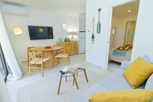 a living room with a couch and a table at Apartamentos São Rafael - Albufeira, Algarve in Albufeira