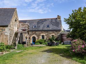 an exterior view of a stone house with a garage at Gîte De L'alliance in Lannion
