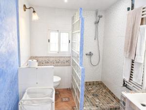 a white bathroom with a toilet and a shower at Masia Pau Prat in Lliçà d'Amunt +48 photos