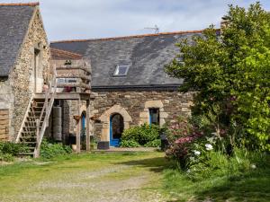 an old stone house with a ladder in front of it at Gîte De L'alliance in Lannion +26 photos