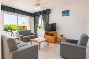 a living room with couches and a flat screen tv at Villa Sotiroula in Kato Yialia