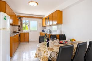 a kitchen with a table with wine glasses on it at Villa Sotiroula in Kato Yialia