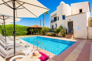 a villa with a swimming pool and a house at Villa Sotiroula in Kato Yialia