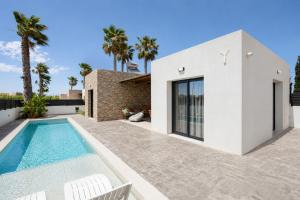 a villa with a swimming pool and a house at Villa Salty Sun 7 in Kremasti