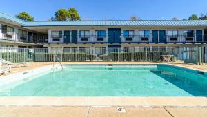 a swimming pool in front of a apartment building at Xpress Inn & Extended Stays in Marshall