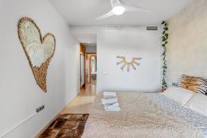 a bedroom with a bed and a heart picture on the wall at Piso La Alondra in Fuengirola +12 photos