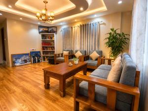a living room with a couch and a table at Monastery View Homestay in Kathmandu