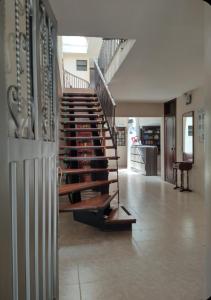 a spiral staircase in a building with a staircase at Hotel Surandino Fátima in Pasto