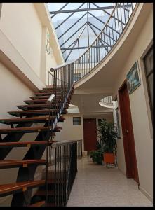 a spiral staircase in a building with a glass ceiling at Hotel Surandino Fátima in Pasto +6 photos