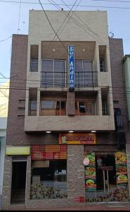 a building with a sign on the side of it at Hotel Surandino Fátima in Pasto