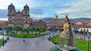 a statue of a woman in front of a building at Hawka Inka hotel cusco in Cusco