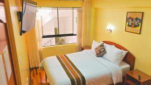 a hotel room with a bed and a window at Hawka Inka hotel cusco in Cusco +19 photos