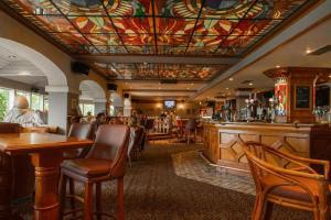 a bar in a restaurant with a colorful ceiling at The Gibside Hotel in Gateshead