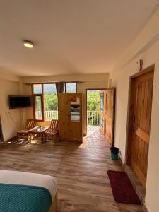 a bedroom with a bed and a wooden floor at Crest Manali River View in Manāli