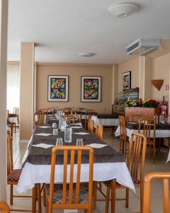 a dining room with a long table and chairs at Nuovo hotel ANTHISA in Lido di Savio