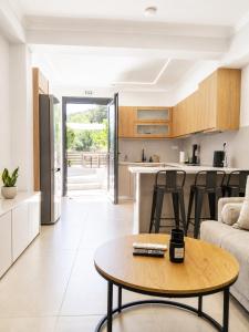 a kitchen and living room with a table and a couch at Calm Horizon Residence in Chios