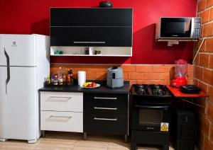 a kitchen with a black and white stove and a refrigerator at Bosque da Lua - Suite with 2 bathrooms - Up to 5 guests in Itupeva +26 photos