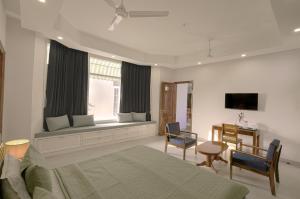 a bedroom with a bed and a table and chairs at IT City Luxe Homestay-Secure & Comfortable Stay in Mohali in Mohali