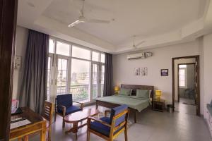a bedroom with a bed and a table and chairs at IT City Luxe Homestay-Secure & Comfortable Stay in Mohali in Mohali