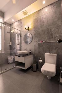 a bathroom with a toilet and a sink at IT City Luxe Homestay-Secure & Comfortable Stay in Mohali in Mohali +51 photos