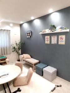 a living room with a table and a table and chairs at Hachi Kamakura KOIWA in Tokyo