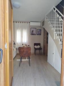 a living room with a staircase and a chair at CASA GORDON in Navaluenga