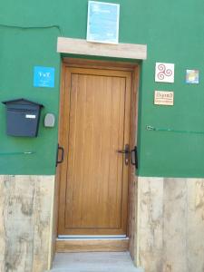 a door in the side of a building with a green wall at CASA GORDON in Navaluenga