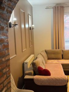 a living room with a couch and a bed at Bukuljska svežina 1 in Arandelovac