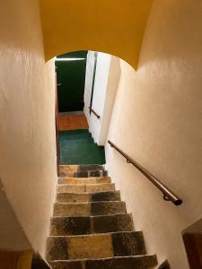 a stairway leading up to a room with a door and some stairs at Apartamentos Saltarel·lo in Besalú