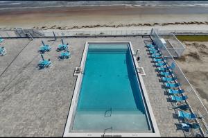 an overhead view of a swimming pool on the beach at Direct ocean front view 1 bedroom 2 Pools in Daytona Beach