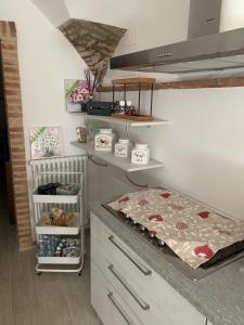 a kitchen with a counter and a stove top oven at Casa Paola in Spello
